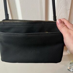 Wallet length black fabric crossbody.